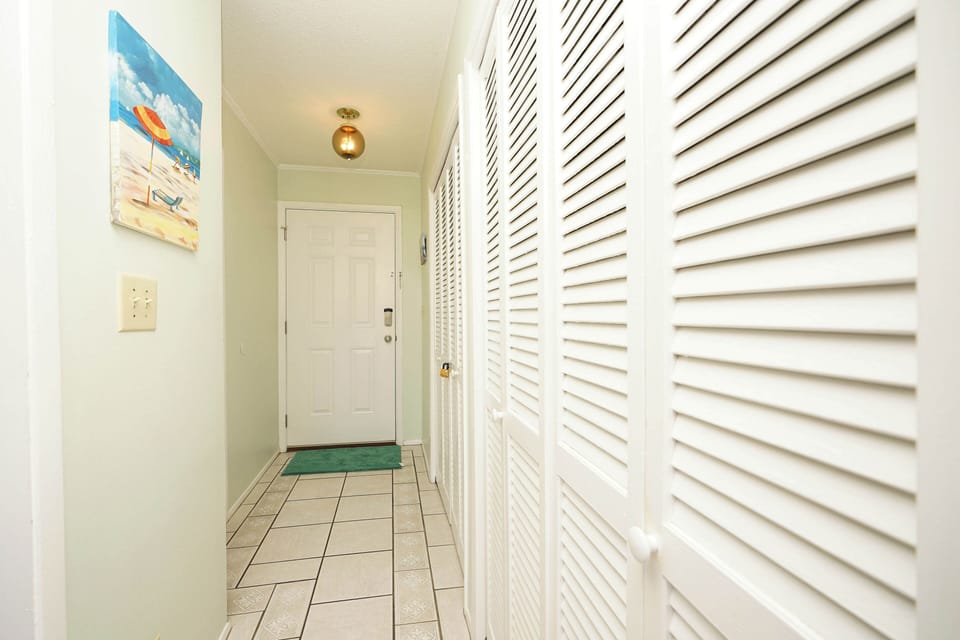 Step into your bright entryway with cheerful beach artwork welcoming you home after ocean adventures.