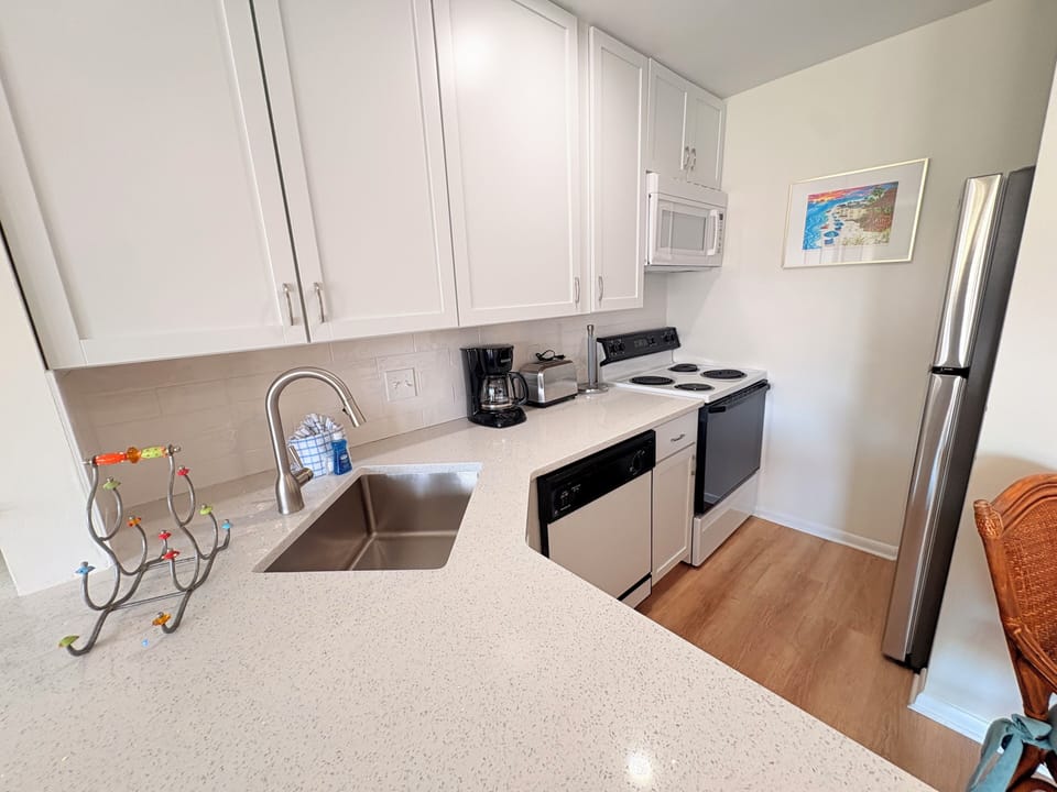 Your fully equipped kitchen features modern appliances, quartz countertops, and everything you need to create memorable meals during your stay.