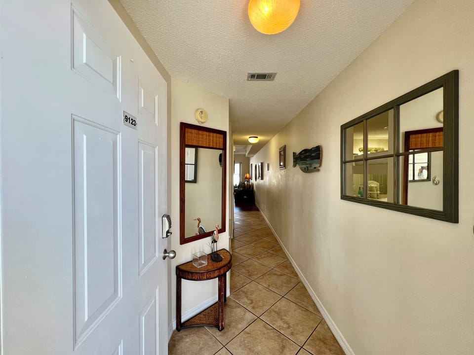 Step into a welcoming corridor leading to your vacation retreat, with warm lighting and thoughtful touches creating an inviting atmosphere.