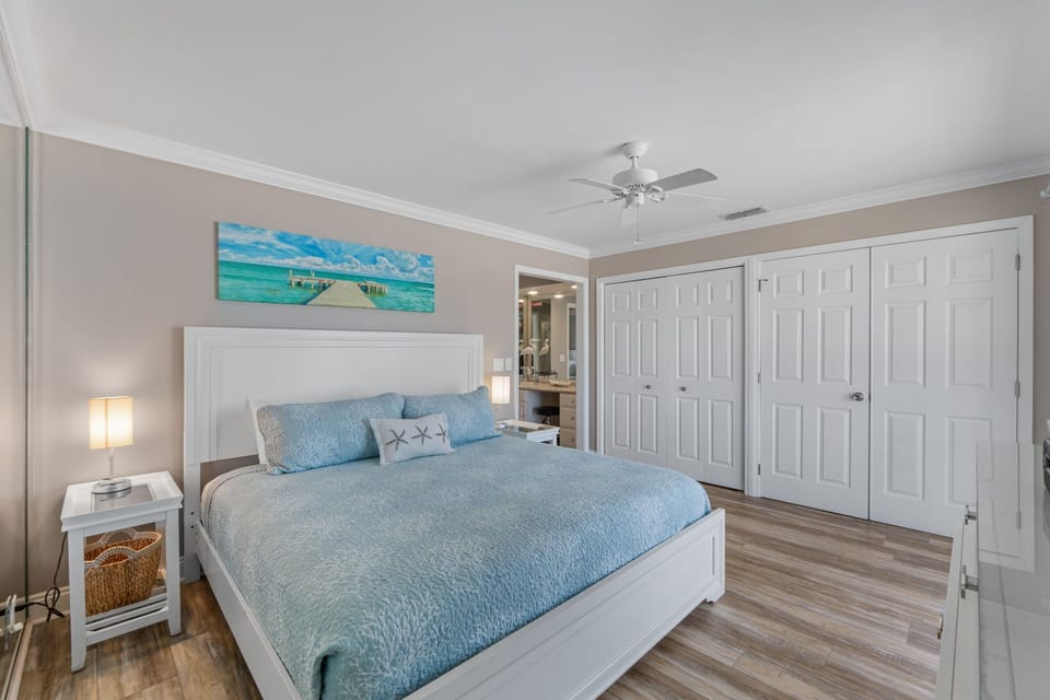 Drift into peaceful dreams in your coastal-inspired bedroom with ocean-blue linens and serene beach artwork welcoming sweet rest.