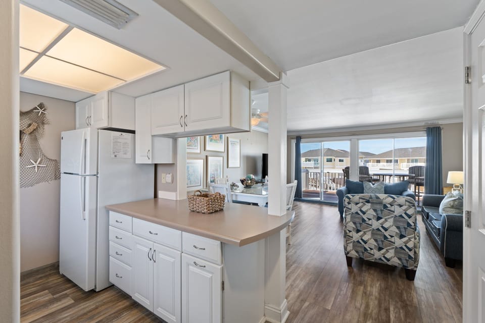 Your open-concept kitchen flows seamlessly into a bright living area where you can cook and connect with loved ones simultaneously.