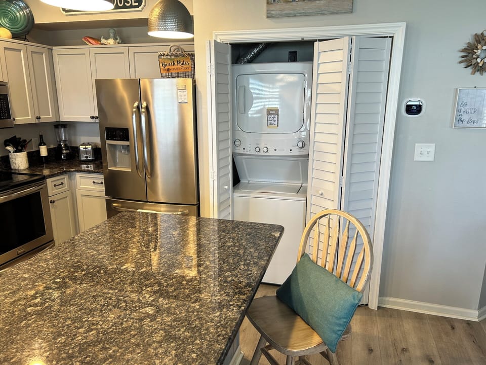 Your fully equipped kitchen features granite counters, stainless appliances, and convenient in-unit washer and dryer.