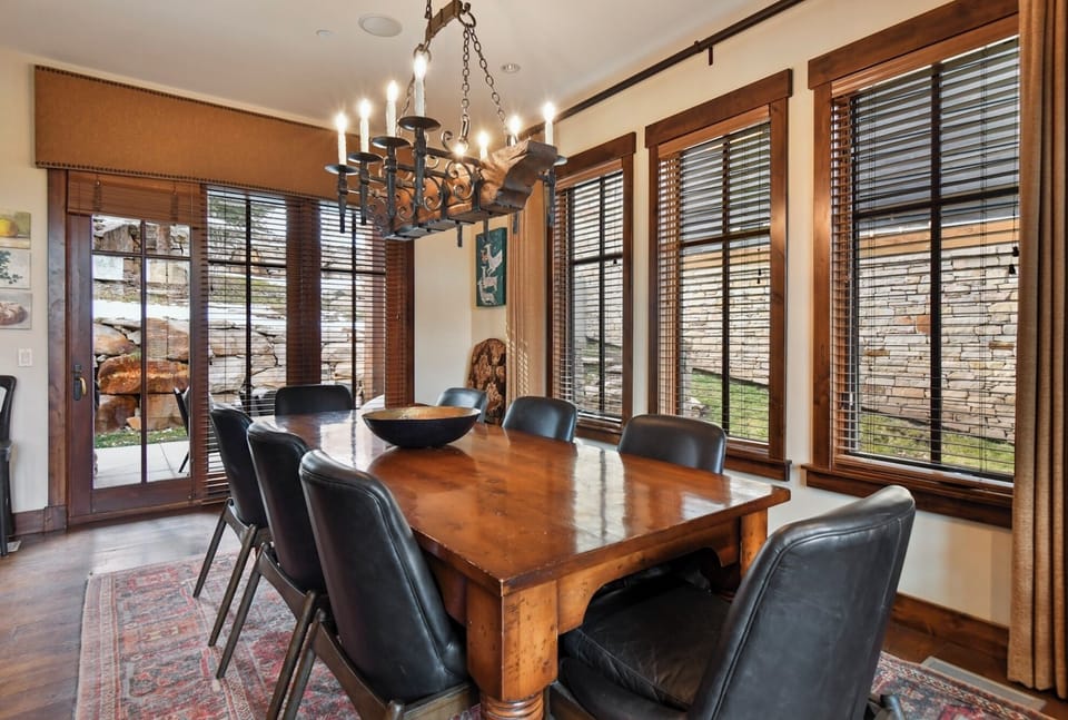 Gather around this stunning rustic dining table where memorable meals unfold beneath elegant candlelight and warm wood accents.