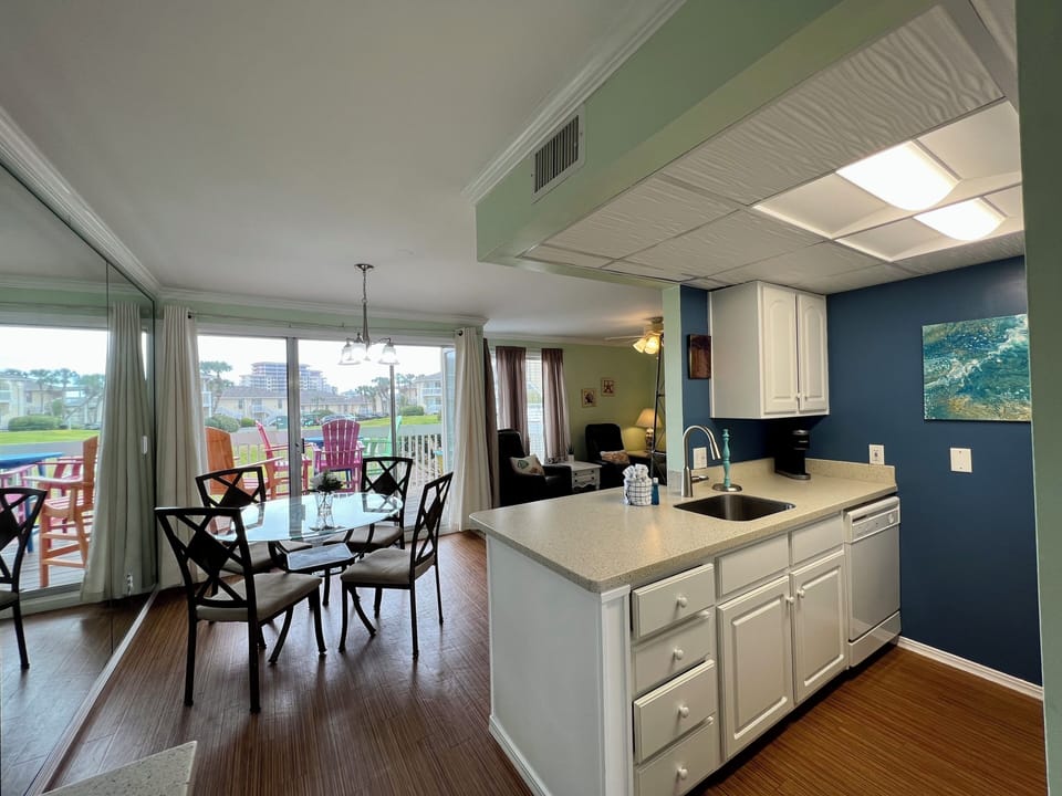 Your open-concept kitchen flows seamlessly into the dining area, creating perfect spaces for cooking and entertaining while enjoying views of the outdoors.