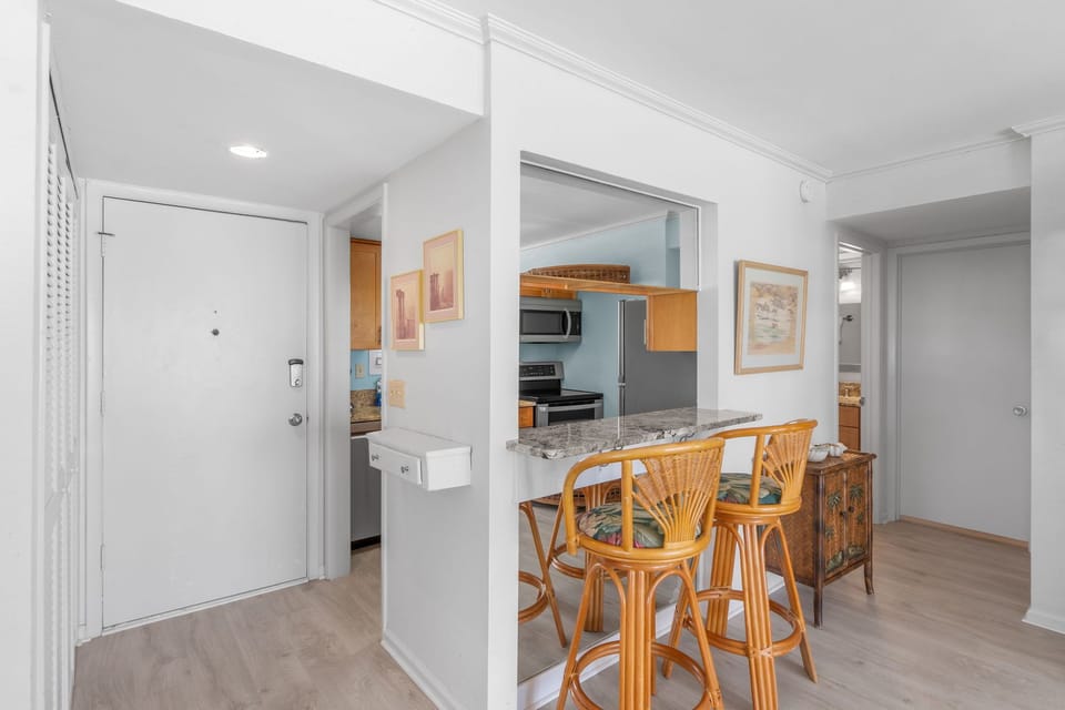 Your bright, open living space flows seamlessly into a fully-equipped kitchen, perfect for casual dining at the breakfast bar.