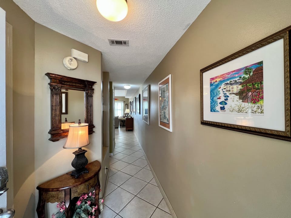 Step into your welcoming hallway, where thoughtful artwork and warm lighting guide you through your vacation home.