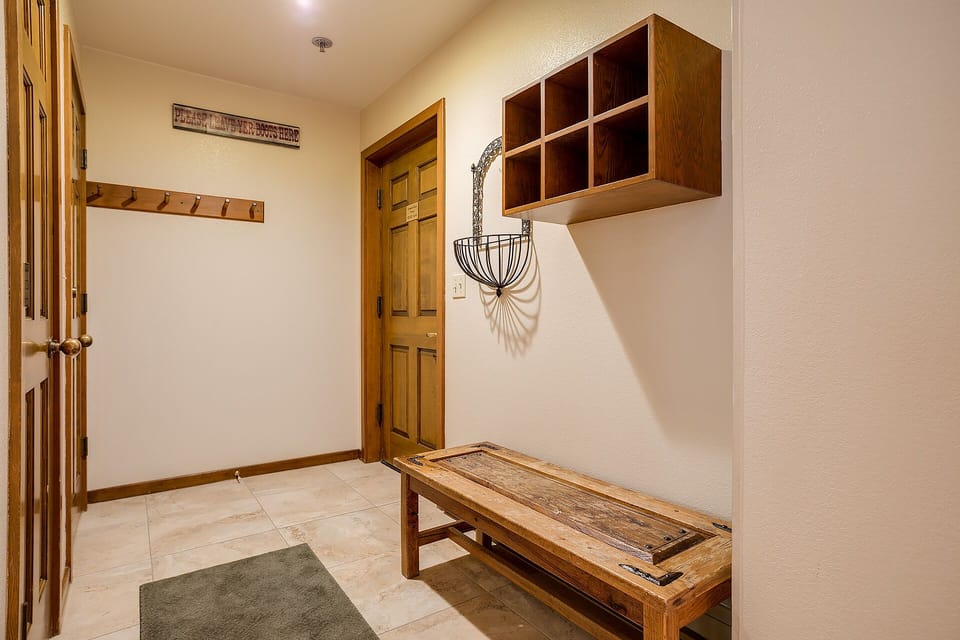 Your private mudroom welcomes you home with rustic charm—hang coats, stash gear, and settle in with mountain lodge warmth.