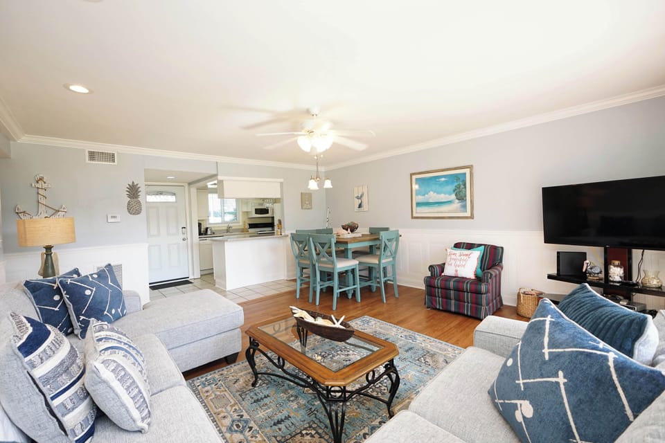 Your bright coastal retreat features an open living space with nautical touches and modern amenities.