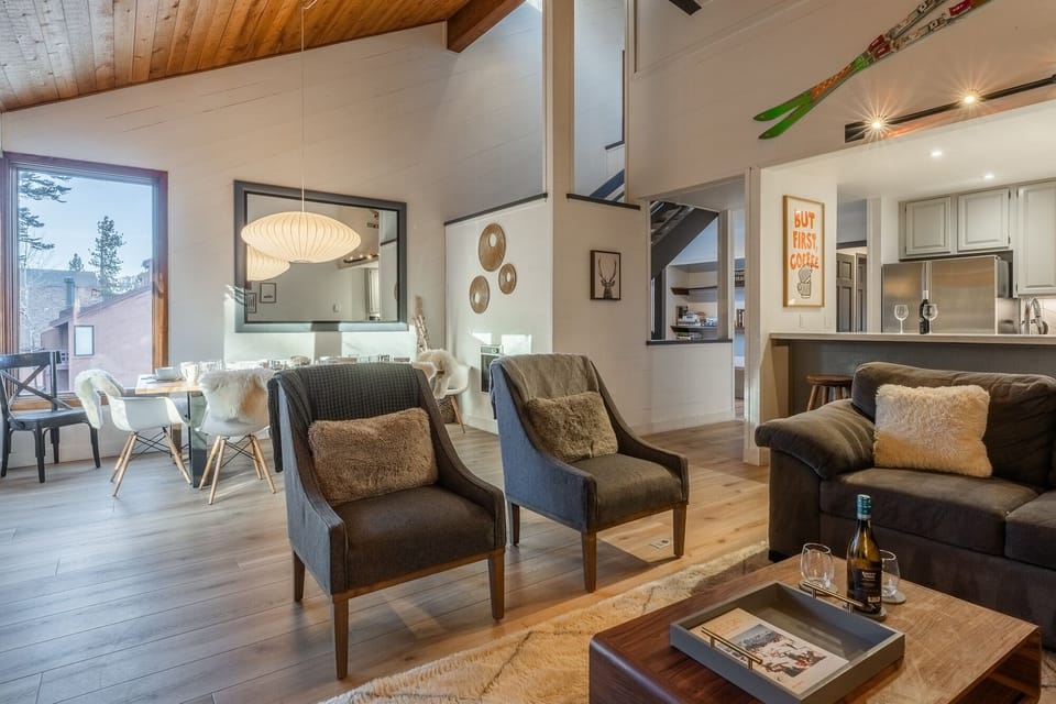 Your spacious retreat blends mountain charm with modern comfort. Sink into plush seating while warmth radiates from exposed wood beams overhead.