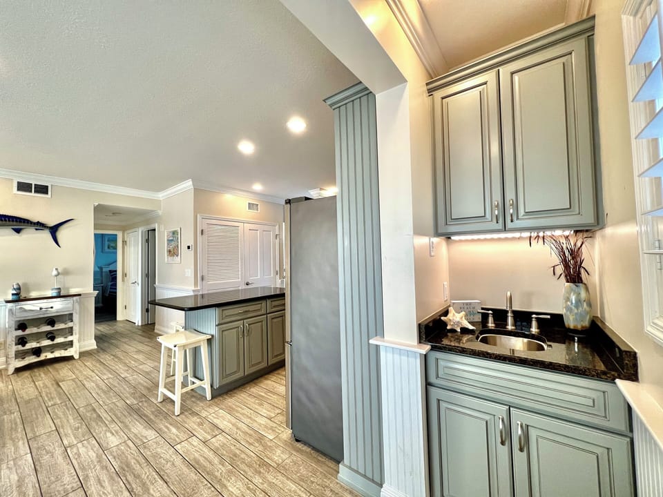 Your coastal-inspired kitchen welcomes you with soft blue cabinetry and rich granite countertops, creating a peaceful retreat for cooking.