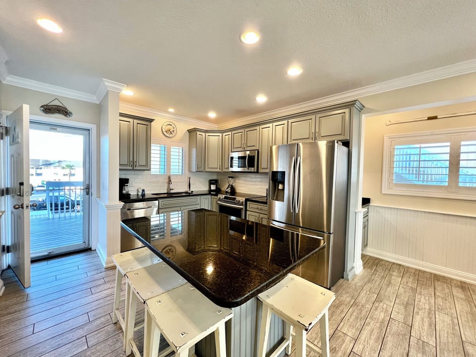 Create culinary memories in this gourmet kitchen with gleaming granite counters, stainless steel appliances, and bar seating perfect for morning coffee.