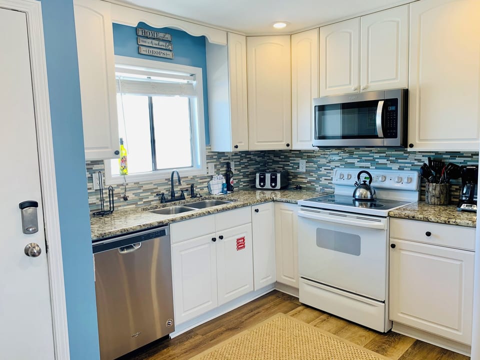 Your fully equipped kitchen awaits with granite counters, modern appliances, and coastal charm for memorable meals.