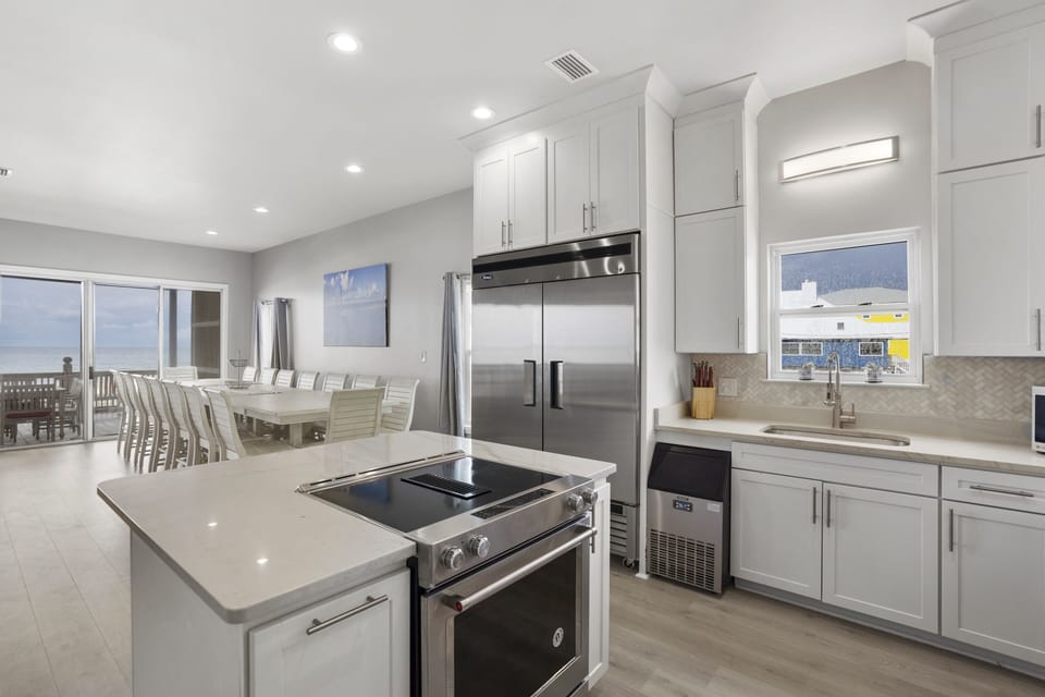 Extra large refrigerator, under counter ice maker, island stove and oven