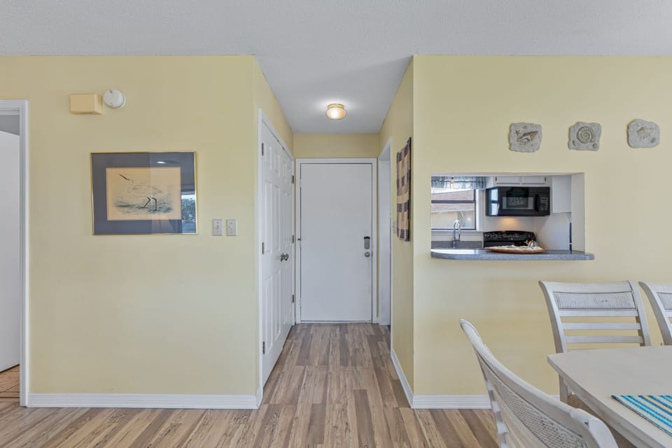 A bright entryway opens to your vacation space, with coastal decor and a convenient pass-through to the kitchen, making it easy to settle in and start relaxing.