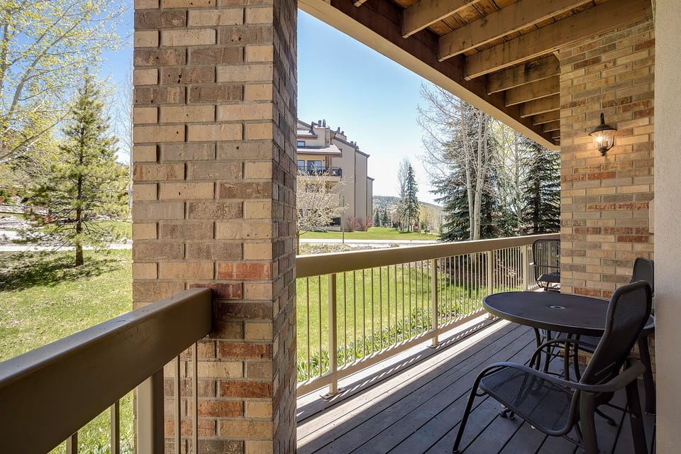 Step onto your private balcony for morning coffee overlooking peaceful grounds and distant mountains, perfect for quiet moments.