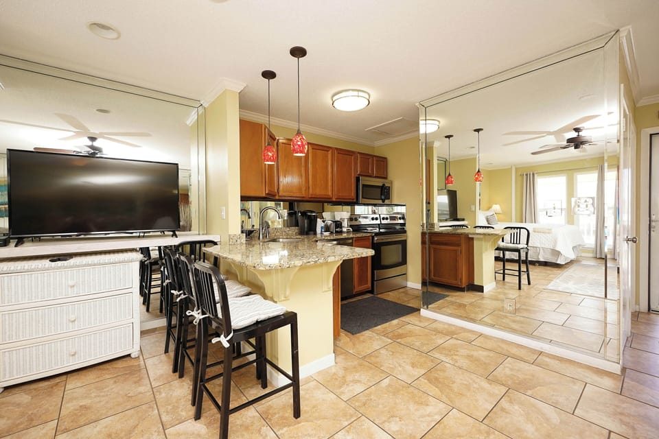 Your spacious open-concept kitchen and living area welcomes you with granite countertops, modern appliances, and comfortable seating for memorable vacation meals together.