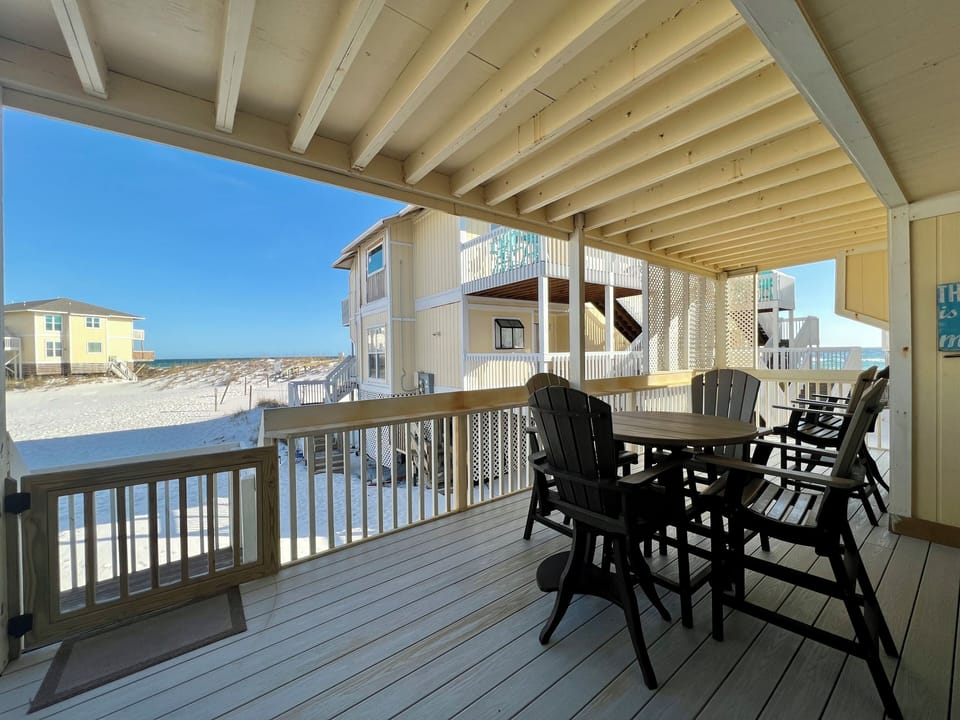 Relax on your covered deck with beach views, perfect for morning coffee or sunset dinners just steps from the sand.