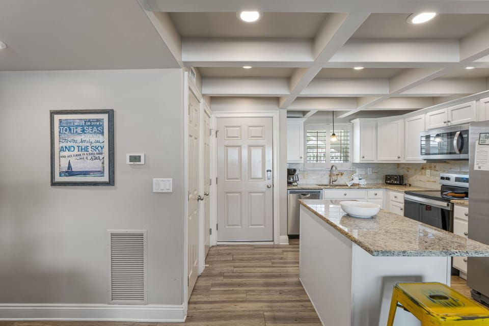 Step into a bright, fully equipped kitchen with granite countertops, modern appliances, and plenty of space for cooking up your favorite meals during your stay.