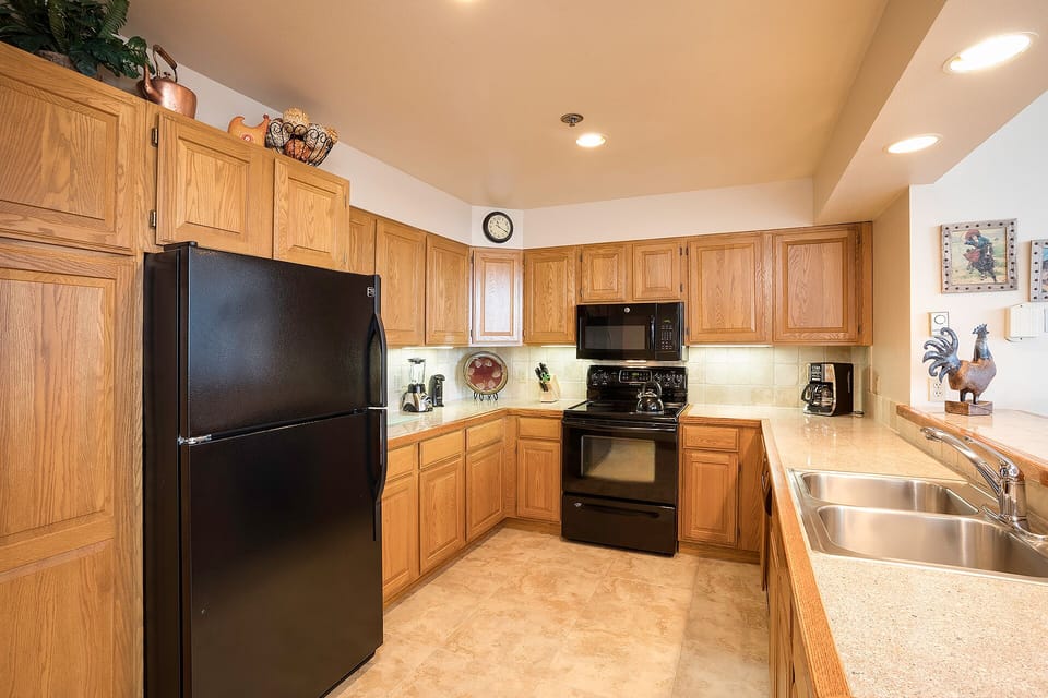 Your fully equipped kitchen invites culinary adventures with warm oak cabinets, modern appliances, and generous counter space for memorable meal prep.