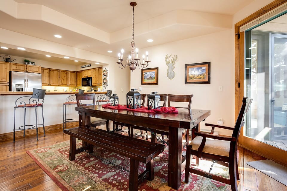 Gather around this rustic dining table where memorable meals await your group, with the open kitchen nearby for easy entertaining.