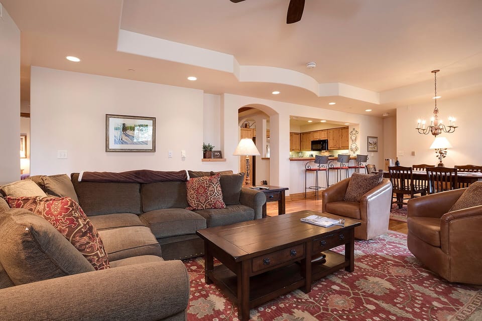 Sink into plush sofas by your cozy fireplace, where warm lighting and thoughtful design create the perfect space for relaxation.