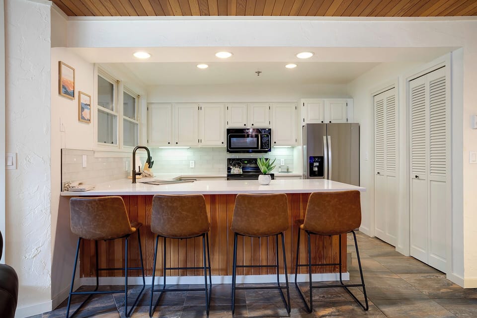 Your fully equipped kitchen features modern appliances and a stylish breakfast bar where you can enjoy morning coffee or casual meals together.