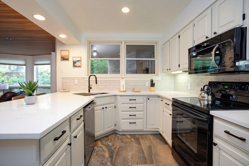 Your spacious kitchen invites culinary adventures with gleaming countertops, modern appliances, and abundant natural light streaming through windows.
