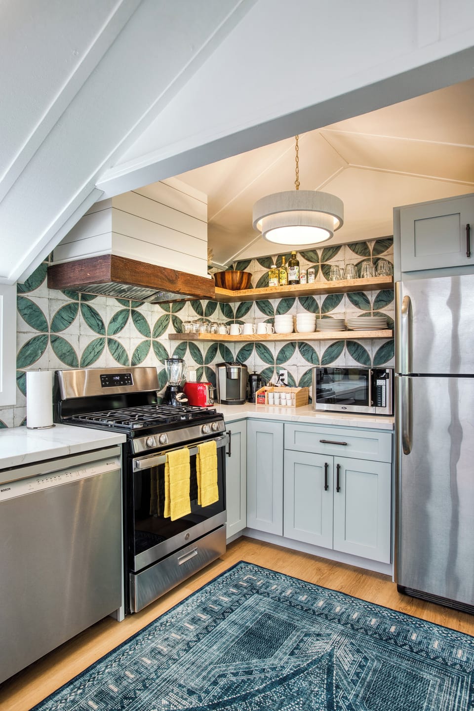 Farmhouse range hood, new appliances, quality cookware, fun design. 