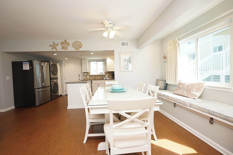 Enjoy meals together at your bright dining table, with a fully-equipped kitchen and cozy window bench creating the perfect gathering space.