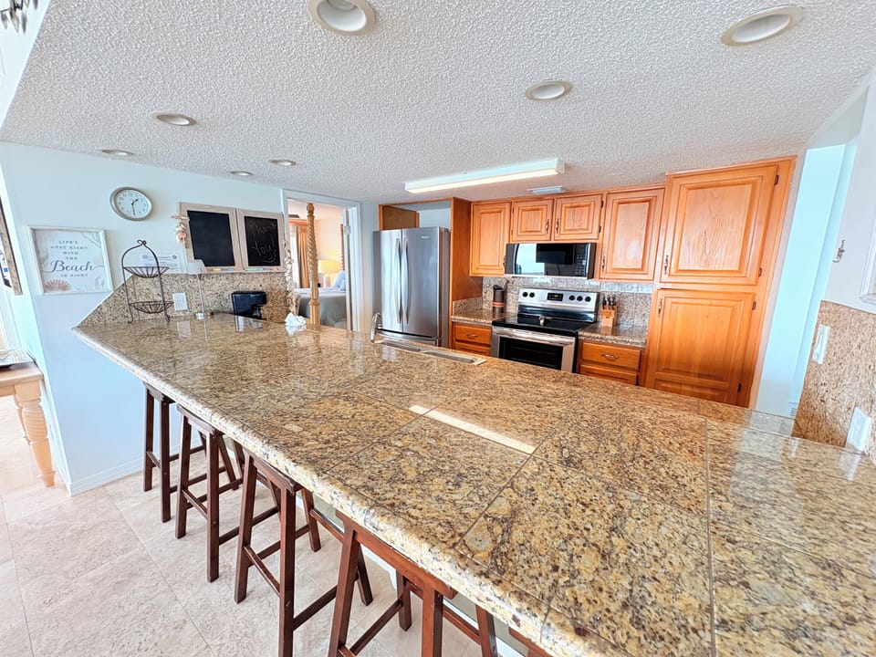 Cook memorable meals in this spacious kitchen featuring granite countertops, stainless appliances, and breakfast bar seating for casual dining.