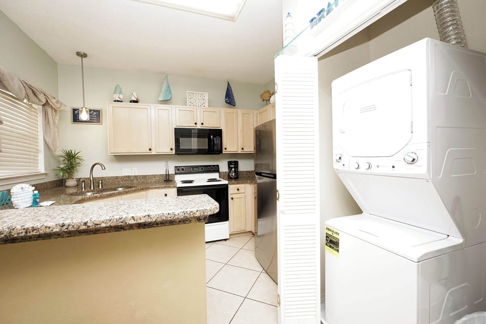 Your fully equipped kitchen features granite counters and full appliances, with convenient in-unit laundry right around the corner for ultimate comfort.