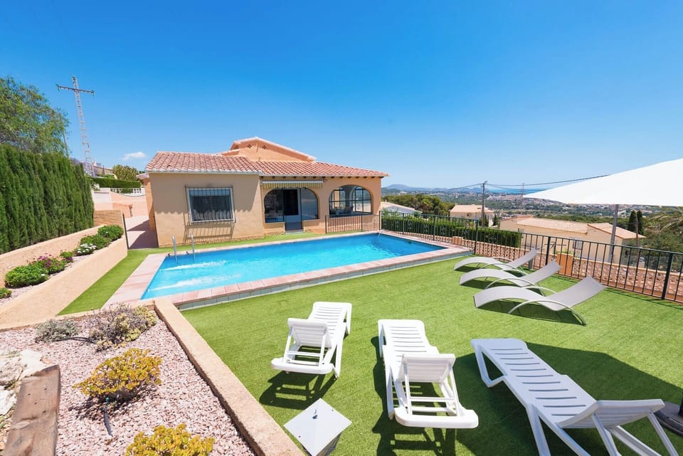 Pleasant holiday villa with private pool and stunning sea views, located in Calpe (COSTA BLANCA) for 8 people. The villa has four bedrooms and three bathrooms distributed over two floors.INTERIOR: This beautiful villa has air conditioning, is composed of two floors connected by external stairs. On the GROUND FLOOR, we will find a bedroom with two single beds and an en suite bathroom with shower. The UPPER FLOOR, consists of a large covered terrace with views of the sea and the pool, with access to living room with Sat / Tdt TV, well-equipped independent kitchen, with mixed kitchen (gas and electric), three large bedrooms (two of them with two single beds in each and one with double bed and en suite bathroom with shower) and finally, a bathroom with bathtub.EXTERIOR: Large closed and wooded plot with pool area with spectacular views where you can enjoy the sun and delicious barbecues. Pool 8X4 (min. 1.10m and max. 1.70m). Parking for 2-3 cars.LOCATION: Enjoy the tranquility just one step away from all services: only 2km separate it from the center of Calpe and its supermarkets and 2.5km from the sandy beaches.OBSERVATIONS: Wifi included. Pets are allowed up to 12kg with supplement.