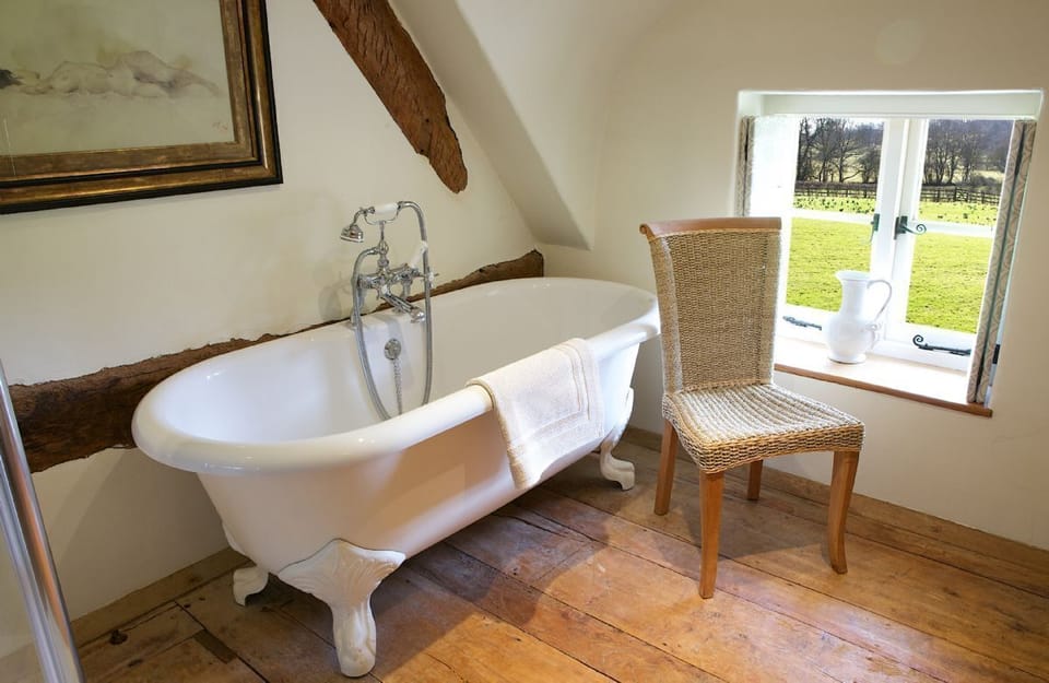 Field Cottage: First floor, roll top bath with a view