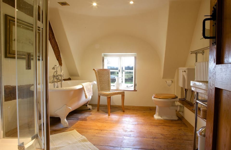 Field Cottage: First floor, Bathroom with a roll top bath, separate shower and heated towel rail
