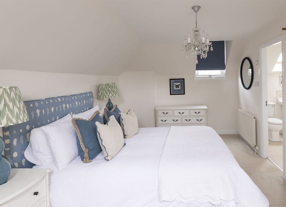 The Mill House - bedroom one with king size bed and ensuite bedroom