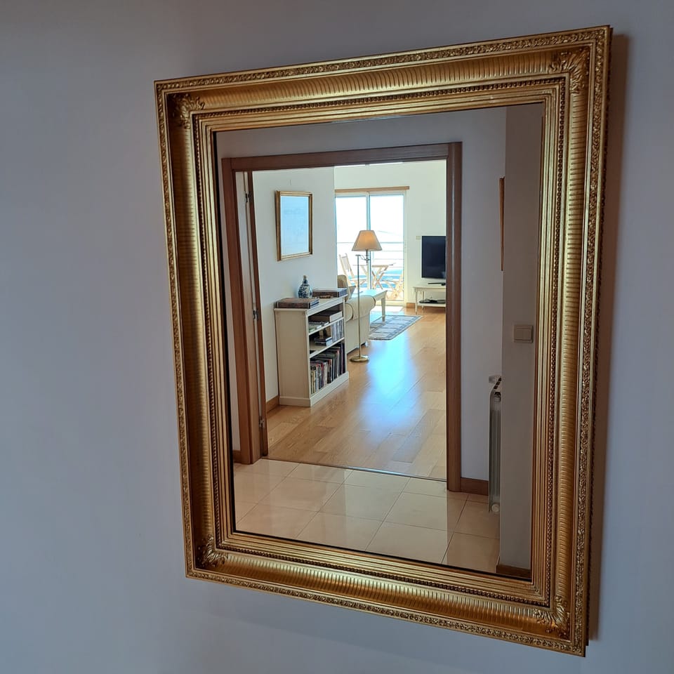 17. Haven in Lisbon. Entrance Hall. Mirror in a carved and gilded wooden frame.