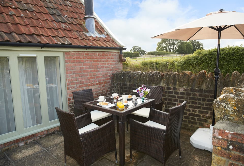 Private outside space with garden furniture seating four guests