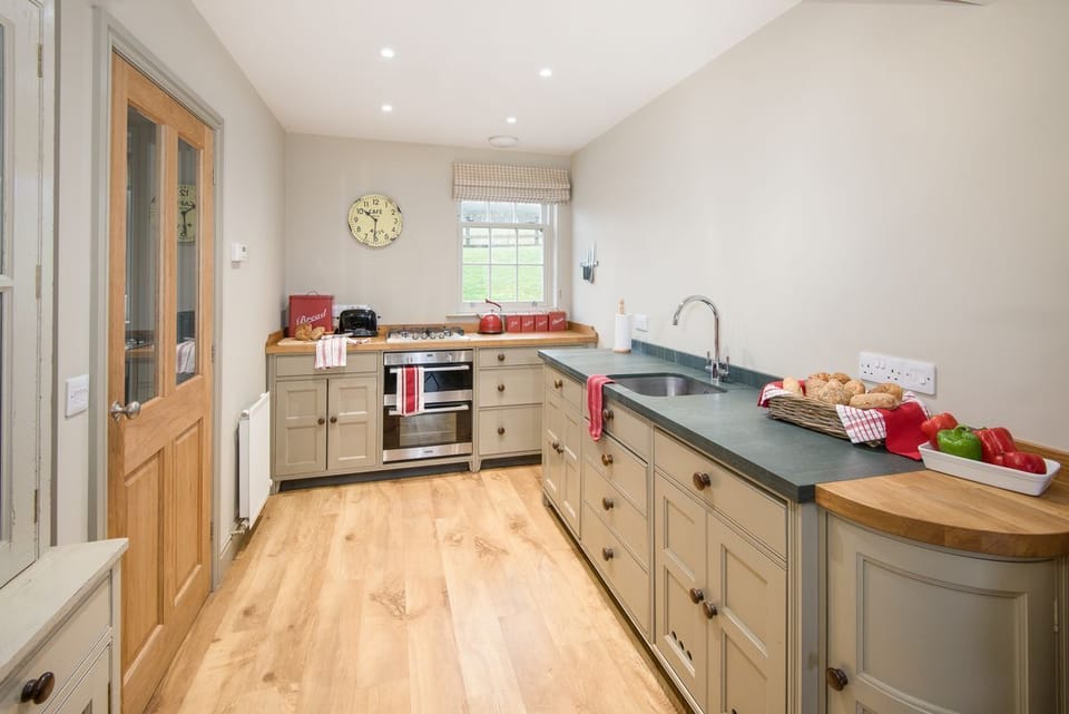 Barley Hill Cottage - the Chalon-style handmade kitchen with door leading to the utility/boot room