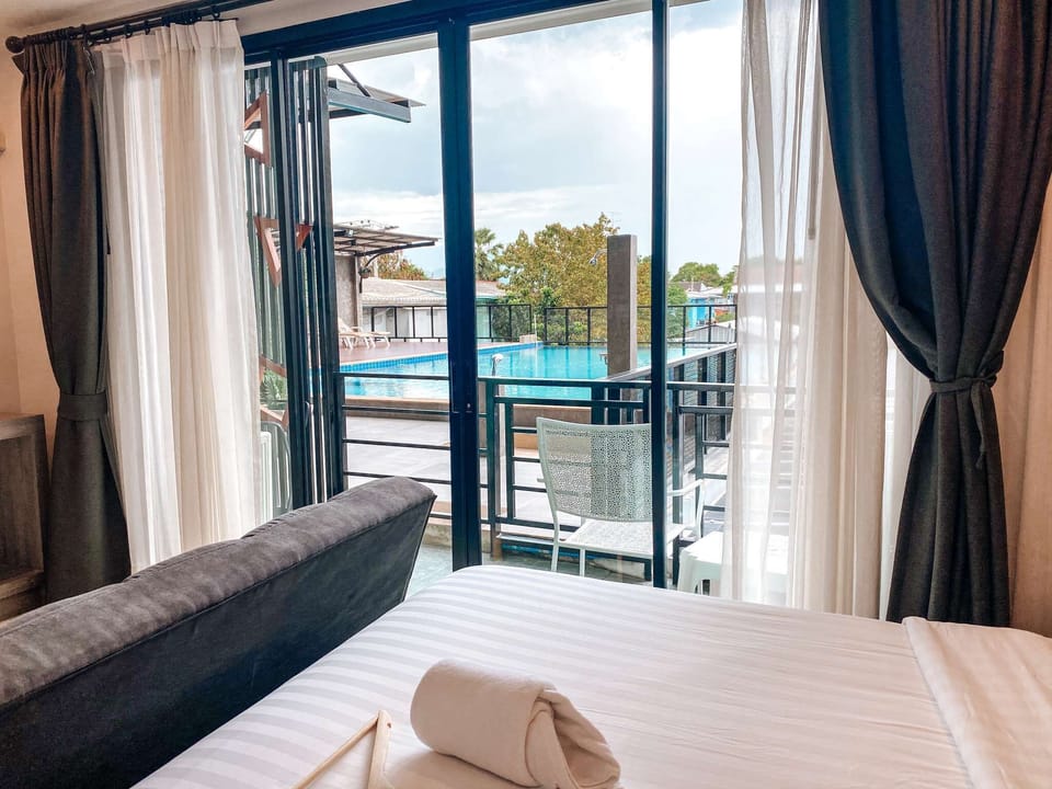 Deluxe Room, Pool View, Poolside | Living area | LCD TV