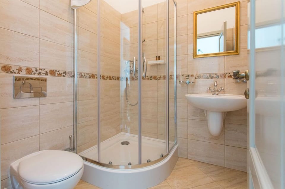 Standard Double Room | Bathroom | Shower, free toiletries, slippers, towels