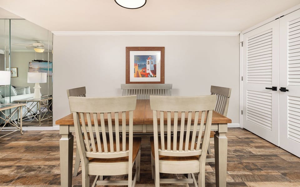 Gather with family around the inviting table, surrounded by art that reflects the vibrant coasts