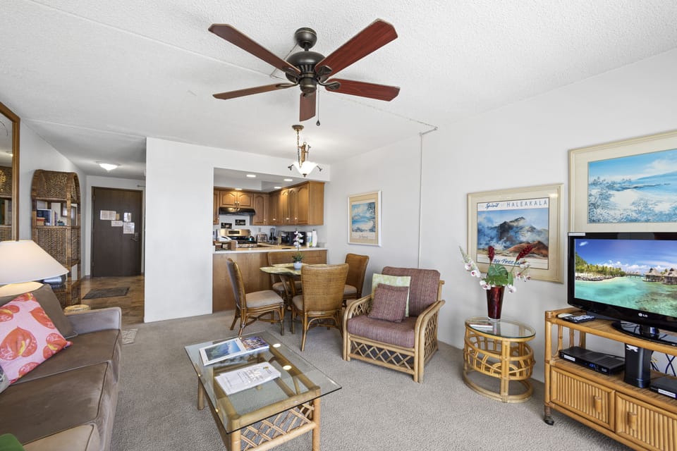 Step into your open-plan living space where coastal charm meets comfort. Relax under the ceiling fan, unwind with entertainment, and enjoy seamless access to your dining area and kitchen.