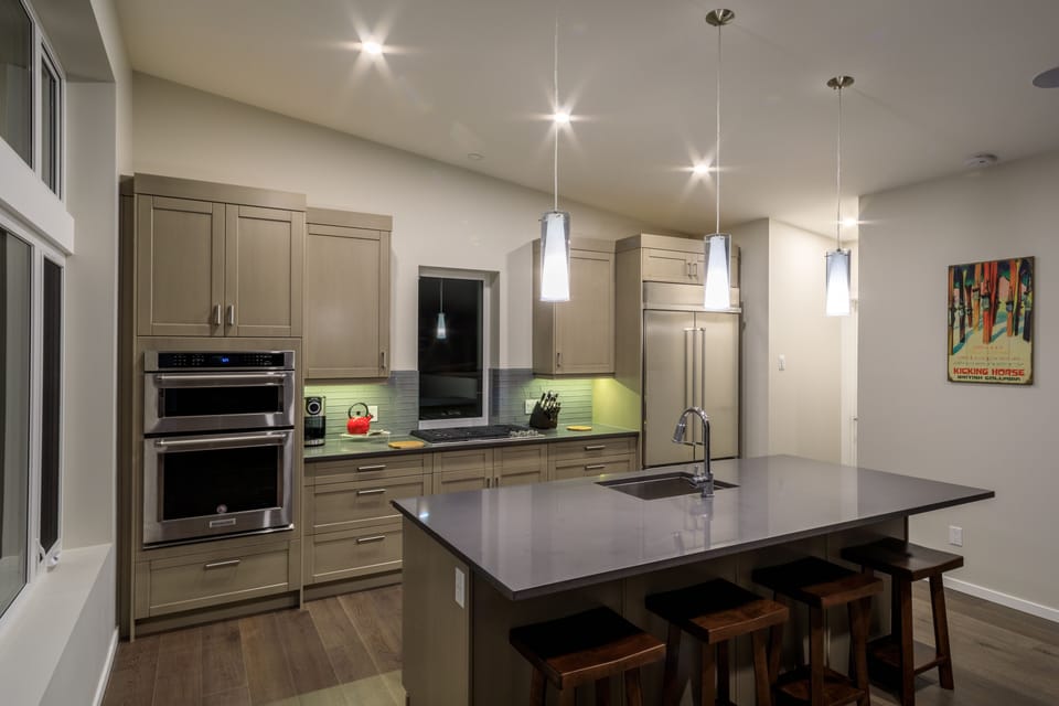 A modern kitchen with gas range w/ downdraft, huge refridgerator, walk-in pantry