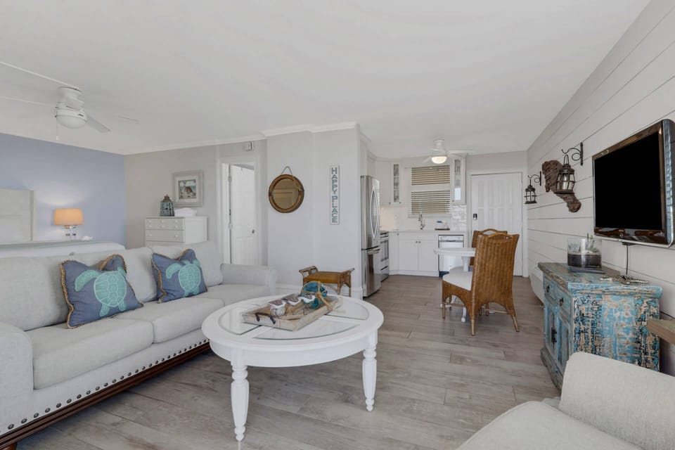 Your descriminating eye will appreciate details such as the custom wood Shiplap accent wall that runs the full length of the condo.