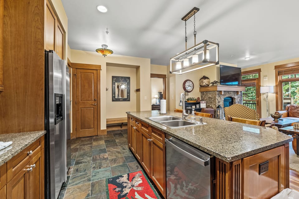 Your gourmet kitchen features granite counters, stainless appliances, and warm wood cabinetry—perfect for creating memorable meals together.