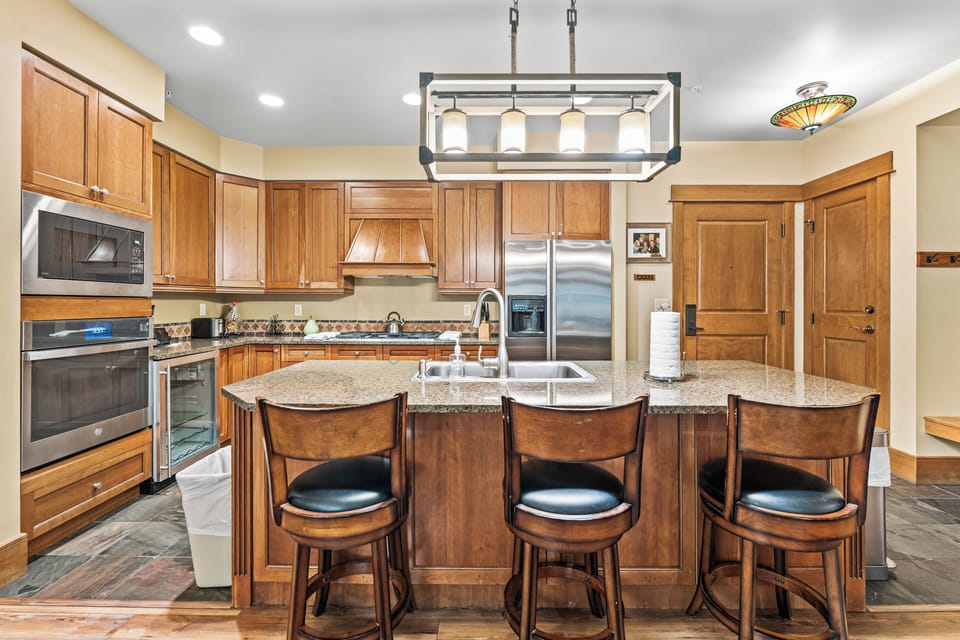 Gather around your spacious granite island for morning coffee or evening meals in this fully equipped gourmet kitchen.
