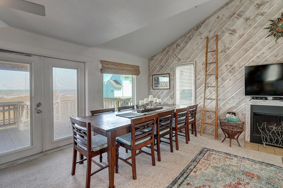 Gather around your spacious dining table with rustic wood accents and coastal views through large windows.