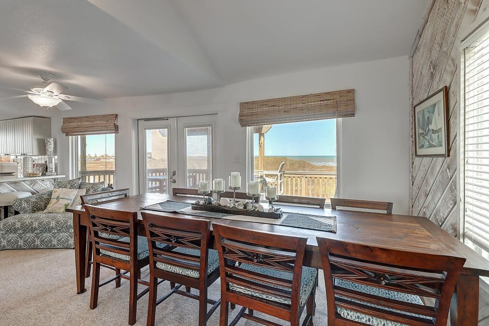 Gather around this welcoming dining table where ocean breezes flow through and stunning coastal views create the perfect backdrop for your memorable meals.
