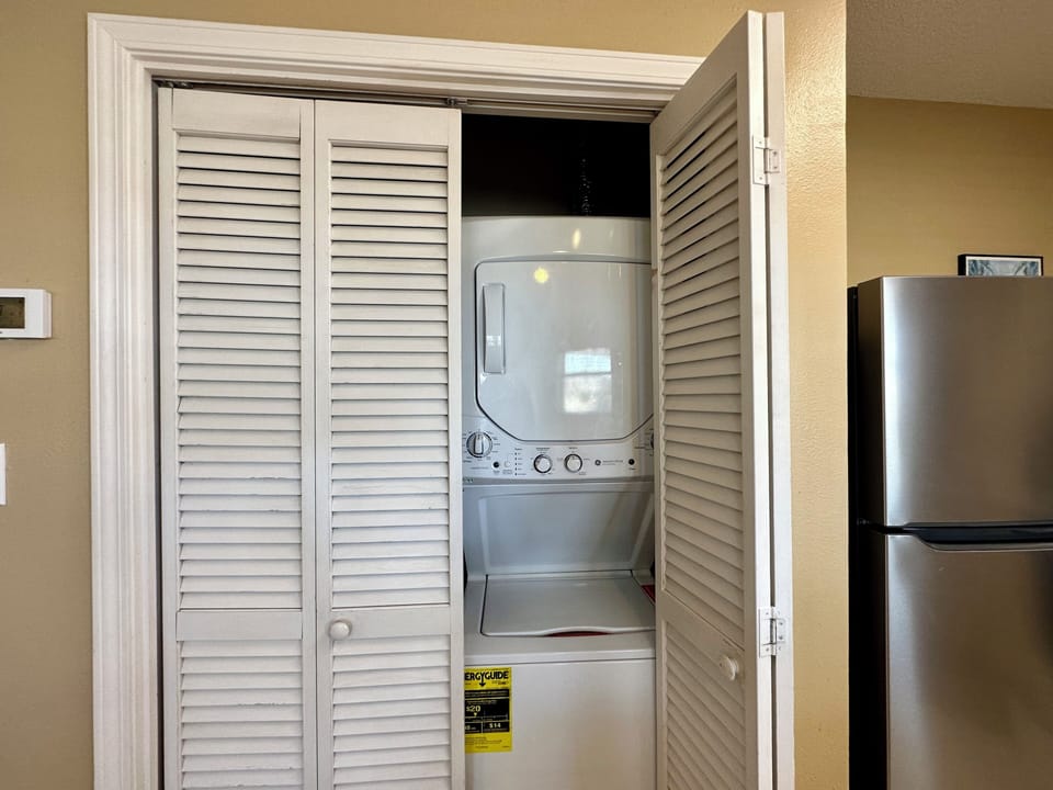 Your in-unit washer and dryer awaits behind elegant louvered doors, making laundry effortless during your stay.