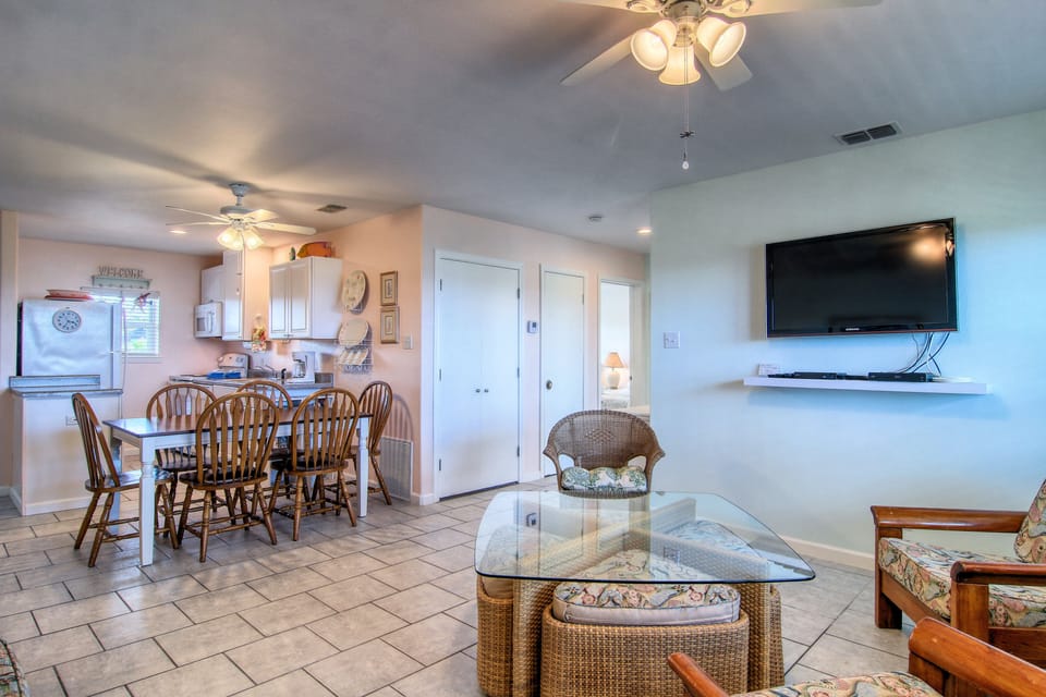 Unwind in your spacious open-plan retreat where coastal comfort meets home convenience, featuring a dining area and relaxing living space.